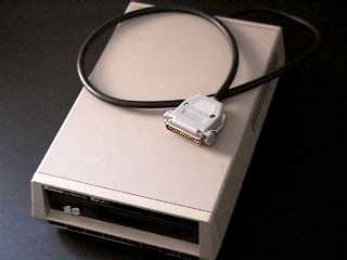 picture of the Xformer Cable and an 8-bit disk drive